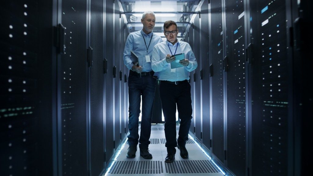 Employees walking inside a data storage room