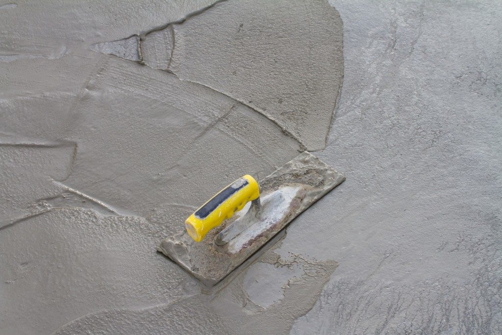 concrete mix being applied to a wall