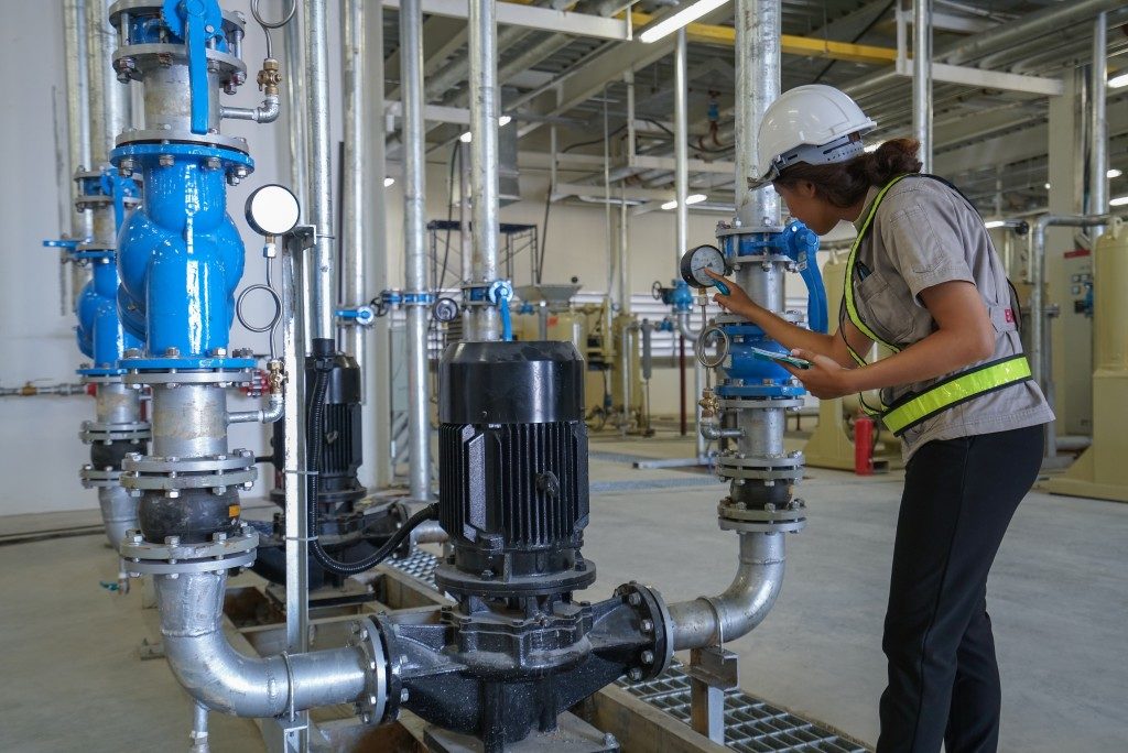 woman checking the piping systems