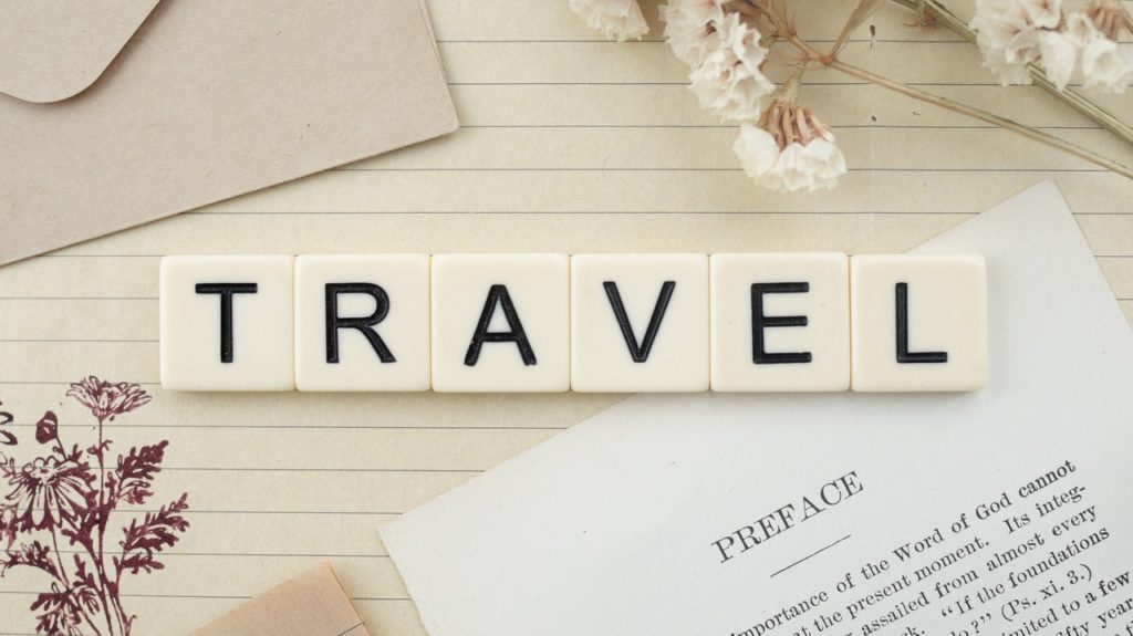 travel spelled with letter tiles