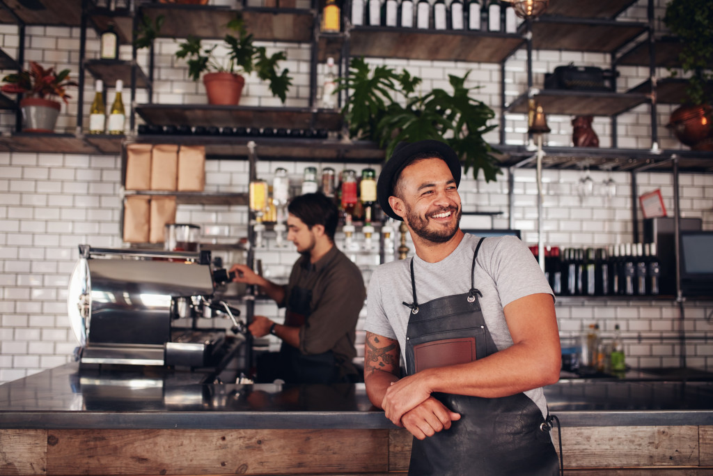 business owner smiling inside his coffee shop