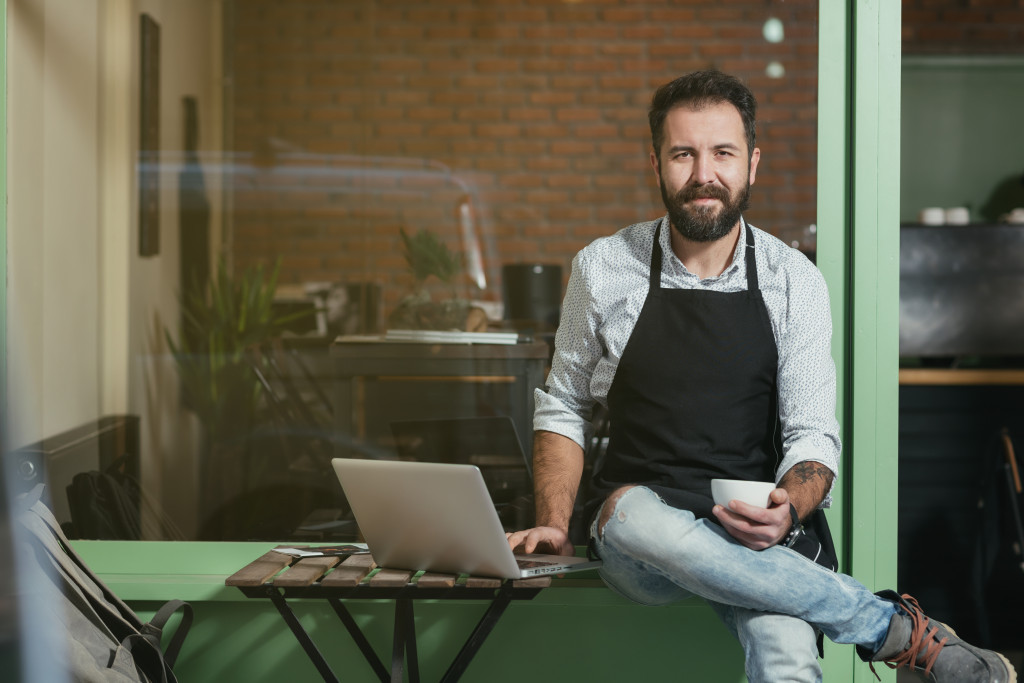 barista working on laptop