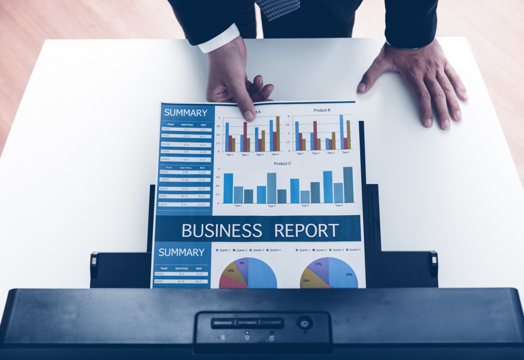 Man in business suit printing a business report