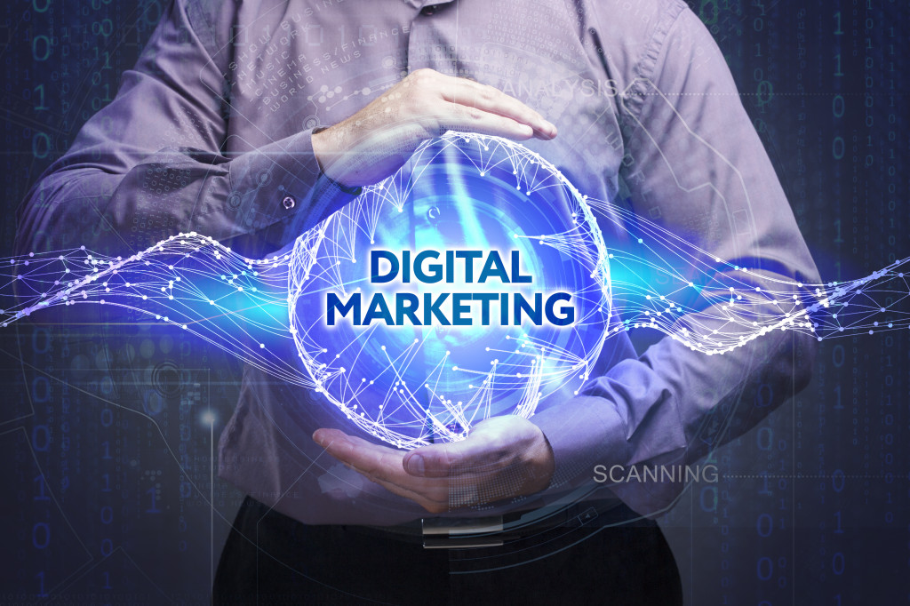 a person holding a holographic image with the text digital marketing on it
